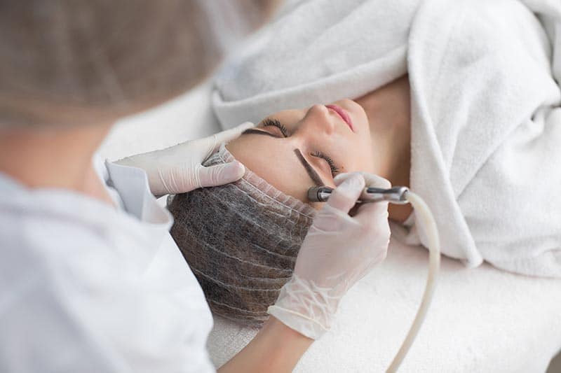 woman getting hydrodermabrasion facial